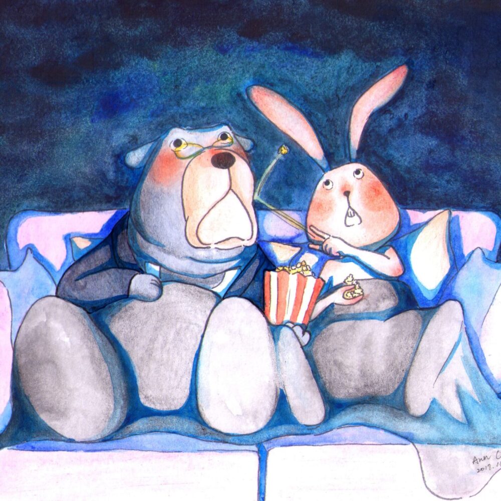 In the Movie Night art print, a bear with glasses and a rabbit with popcorn sit on a couch, looking surprised while watching TV. A blue blanket covers their laps, adding coziness to the nighttime setting.