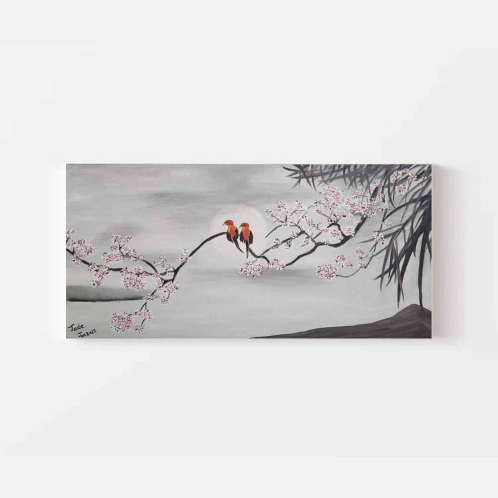 The Lovebirds By The Moon art print showcases two birds perched on a branch with pink blossoms and a glowing sun against a gray background, highlighting bamboo silhouettes swaying gracefully on the right side.