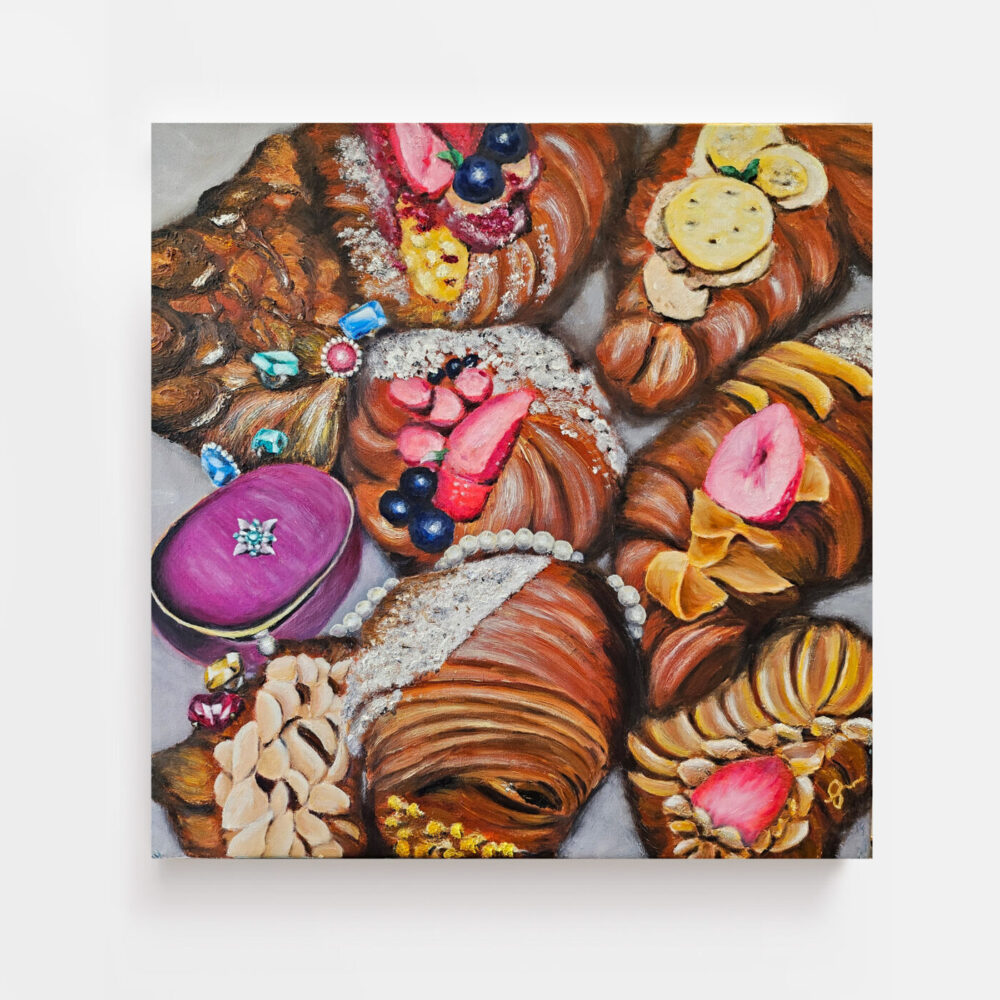 The art print Colourfully Delicious features vibrant croissants decorated with berries, nuts, rings, and pearls. Its a detailed painting with a luxurious and whimsical theme that captivates the eye.