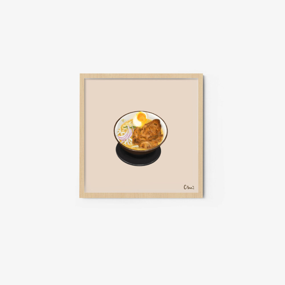 The Roasted Chicken Laksa art print showcases an illustration of a ramen bowl with noodles, sliced pork, a boiled egg half, and green onions. Its elegantly framed in light wood against a neutral background.