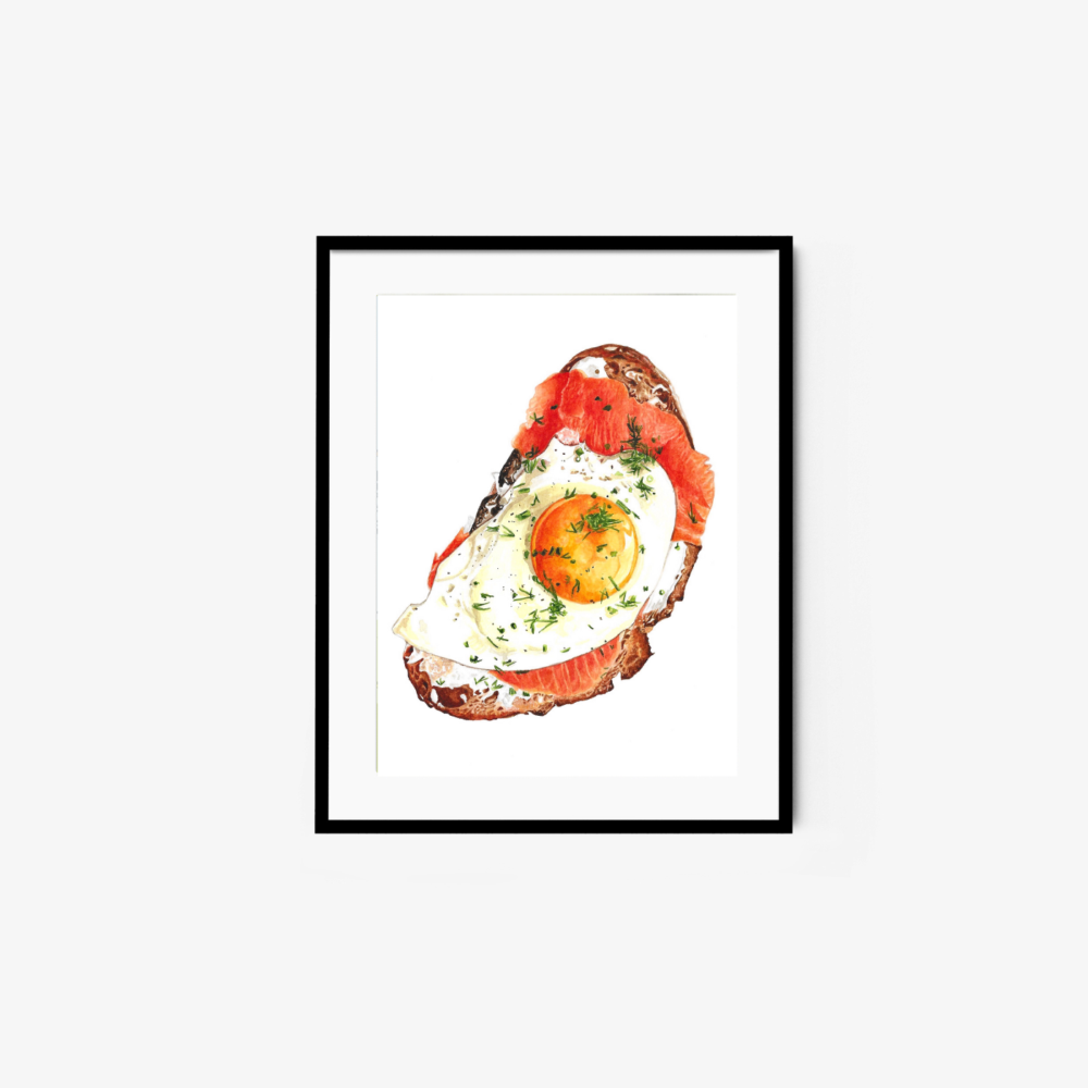 Art print titled Smoked Salmon and Egg Toast, showcasing a framed painting of an open-faced sandwich with smoked salmon, a sunny-side-up egg, and fresh herbs on bread against a plain white background.